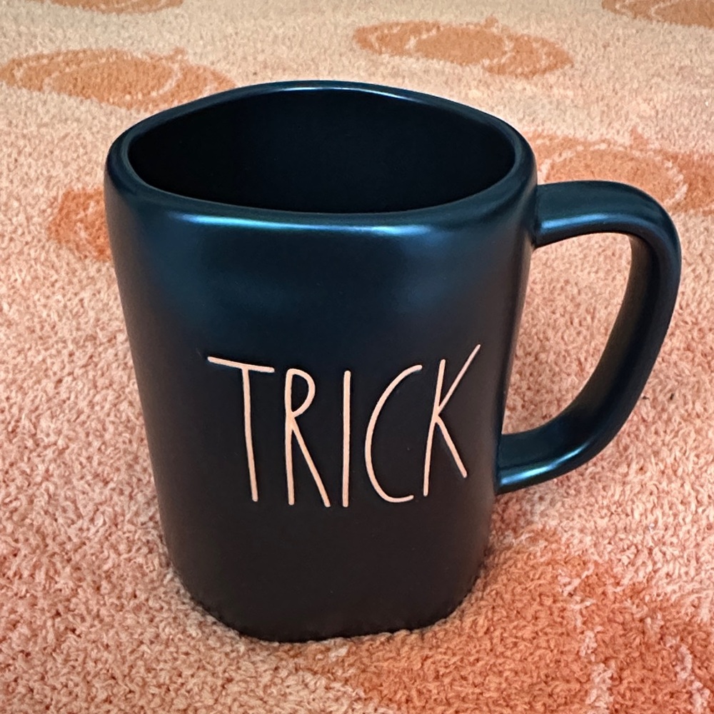 Black Rae Dunn mug, double sided with “trick” and “treat” in orange lettering!